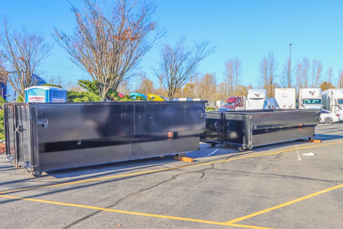 Professional dumpster rental service with roll-off container on residential driveway in Imperial